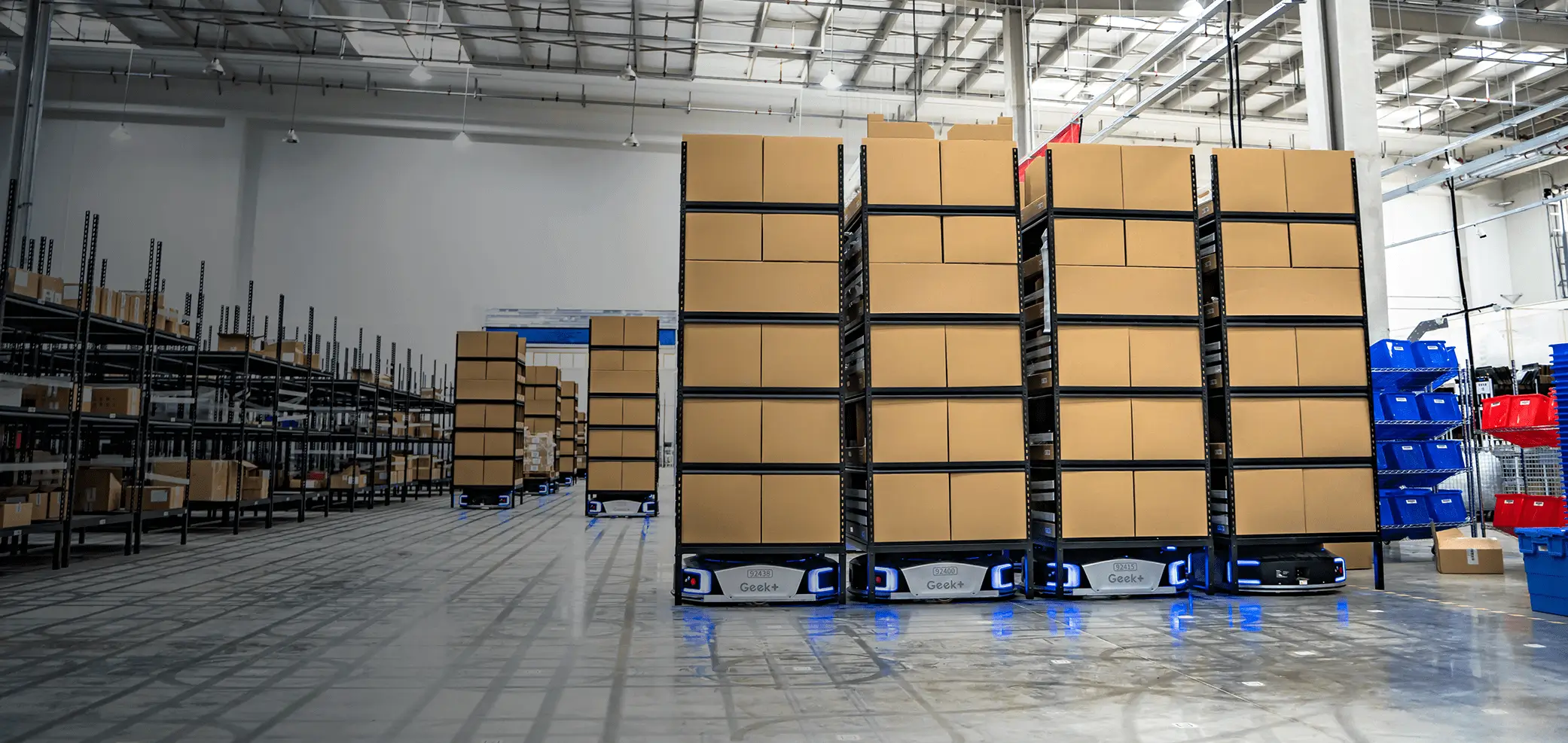 A warehouse with boxes stacked on Geek picking robots. Shelf-to-person picking system.
