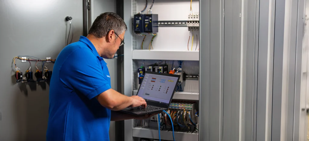 A man working on warehouse automation equipment