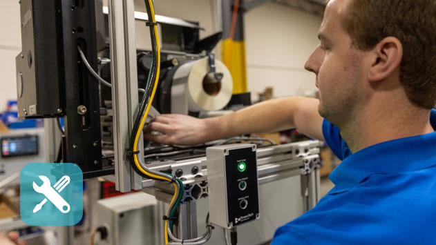 A man conducting maintenance on warehouse systems.