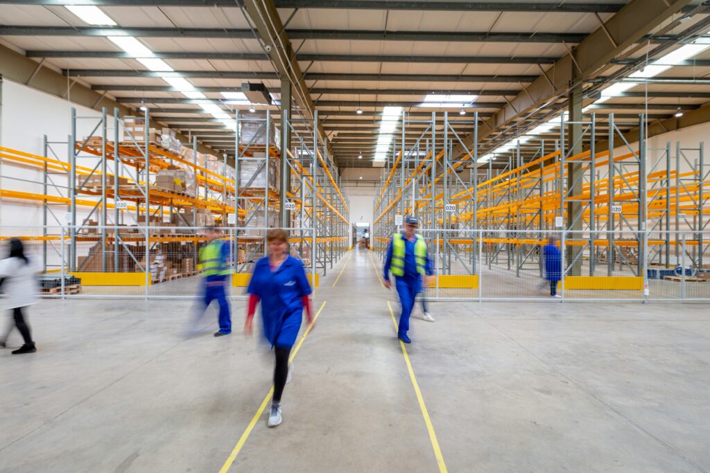 Workers manually working in a shipping warehouse. 